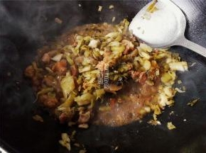 另起一锅，热锅冷油，升温后把酸菜倒入炒制，再把炖煮好的牛肉倒入继续翻炒。