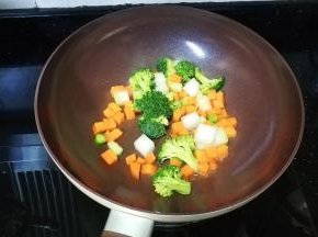 锅里热油倒入蔬果丁炒均匀