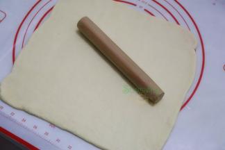 .把发酵好的面团揉搓，挤出面团内的空气，用擀面杖擀薄成四方形。