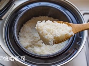 焖好的米饭焖一会再开盖，看这米饭是粒粒分明，用饭勺将米饭搅拌散热。小鲜米非常香，焖米饭的时候满屋飘香味，大米的香味太好闻了。