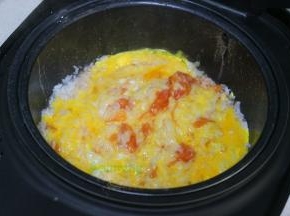 鸡蛋去壳，打入一个陶瓷碗里，用打蛋器调均，把鸡蛋倒入电饭锅里，并且搅拌均匀。