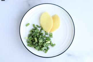 切两片姜片，葱切成小粒状。