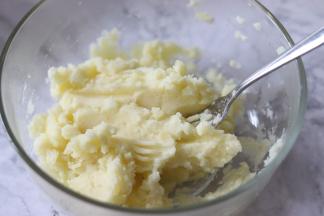 把土豆放到一个容器中，趁热用叉子压成细腻的土豆泥。