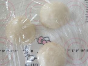 7、取出分割成3份，滚圆盖保鲜膜松弛10分钟。
