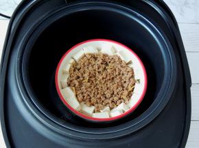 将豆腐肉末放入甄锅里面，然后将甄锅放回三角釜中。