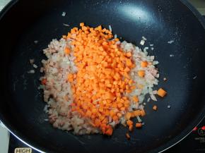 将培根放入锅中，煸炒均匀，然后放入胡萝卜粒，翻炒至软。