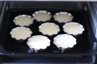 把所有的做好后，放入烤盘中，烤盘需要放入温水，高度大约是模具高的一半。