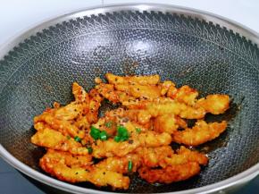 放入炸好的鸡肉条翻炒，撒上黑芝麻，葱花翻炒均匀，关火出锅。