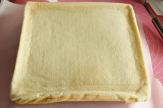 等3分钟左右，卷温度慢慢降下来，直接翻卷蛋糕卷，轻轻撕开底部的油纸，毛巾面来啦。今天就是要用到这一面。