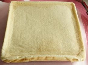 等3分钟左右，卷温度慢慢降下来，直接翻卷蛋糕卷，轻轻撕开底部的油纸，毛巾面来啦。今天就是要用到这一面。