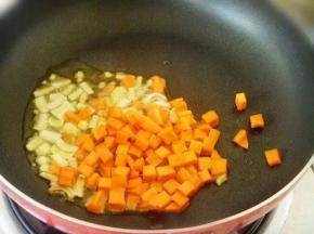 9 锅热放少许油，温热放入葱姜煸炒，炒香了放入红萝卜丁。