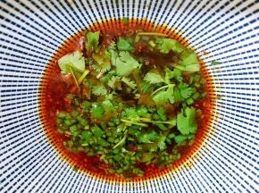 舀入两大勺面汤拌匀做料汁，撒上葱花和香菜末