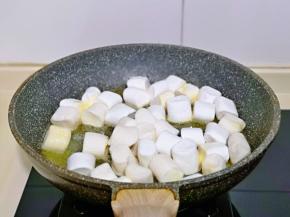 待黄油融化为液体后，加入棉花糖，同样小火将棉花糖炒化。