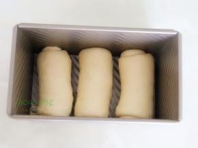 卷好的面团放入450克的吐司盒，烤箱内放一盘温水，吐司盒放入烤箱内，时间45分钟，功能按发酵温度在38度左右