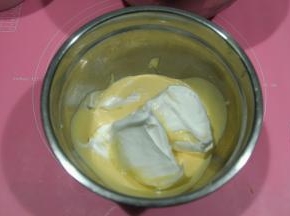 取1/3蛋白霜到蛋黄糊中，左手配合逆时针转盆，右手用蛋抽从色中心切入，从盆底往盆边翻起，打蛋器上的在盆边敲下，重复切拌，翻拌动作，初步混匀。