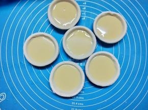 将蛋挞液倒入挞皮中，七八分满