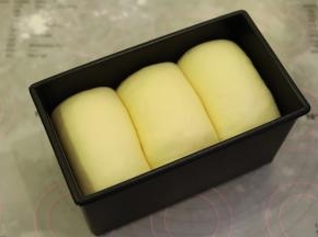 同个方向放入450克低糖不沾吐司模内，发酵箱设置温度为32度，湿度75度，一小时左右，发至模具八成模高。