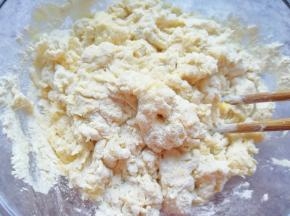 分次加入油条粉中，用筷子挑拌成絮状。