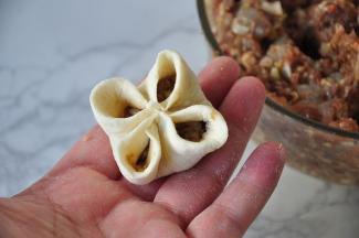 分别用左右手的拇指和食指推着饺子皮向中间合拢，然后在中间部位捏紧定型。我自已包没法将做法拍下来，您可以通过网络搜一下。