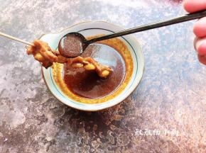 8分钟烤好，戴上防烫手套，拿出烤盘，在鸡脆骨上淋上酱汁，洒上白芝麻，再次摆在烤盘上
