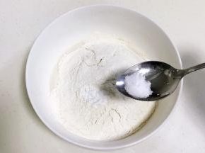 往大碗内加入酵母牛奶液、糕点用小麦粉、小苏打和盐。