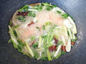 下入准备好的生姜、洋葱、大葱、香菜、胡萝卜、八角和丁香，小火炸8–10分钟左右。