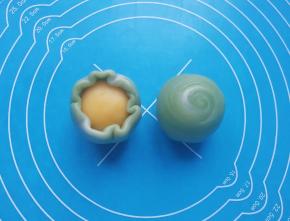 用虎口慢慢向上推挤收口，最后将收口朝下摆放，一个螺旋绿豆酥就完成了。