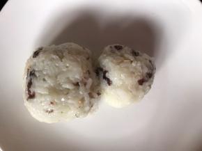 用保鲜膜或保鲜袋包裹米饭，捏成一大一小的两个饭团，摆入盘中