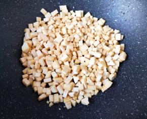 炒锅烧热倒入适量的食用油，下入豆腐干小火炒至金黄色。