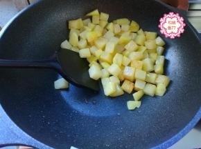 油热后把土豆丁放进锅里，一点点油就够了，完全不会粘，土豆粒勤翻动，别煎糊了。