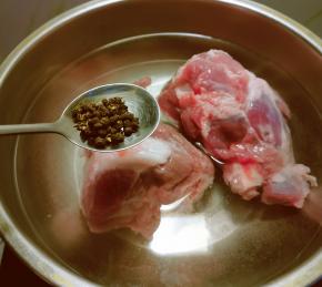 锅中放入清水 放入猪骨 放入花椒粒 水烧开给猪骨汆水