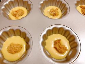 先放少许面糊在模具里，再放入一小坨颗粒花生酱