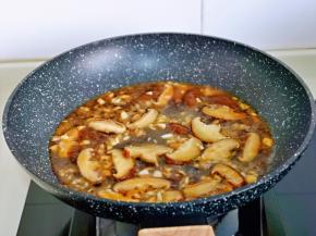 倒入蒜蓉酱汁，大火烧开后转中小火将香菇煮熟。