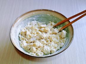 分次倒入面粉中，一边倒一边用筷子搅拌成絮状，揉成光滑面团，盖上保鲜膜醒30分钟。