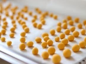 之后，取出一部分，放到案板上，搓成长条，切成小块，之后搓圆，南瓜圆子就制作完成了。