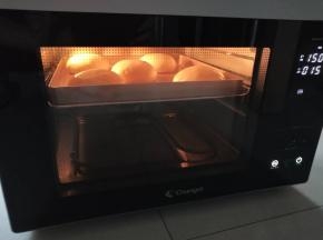 7、烤箱中下层150度，先烘烤15分钟后将喜饼翻面，在面团上压一个烤盘再烤15分钟。