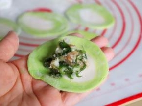 取一块擀好的饺子皮，放入饺子馅，包出自己喜欢的形状。