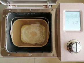 往面包桶里依次倒入水、蛋液、糖、盐、奶粉和面粉，在面粉顶端倒入酵母。把面包桶放入到东菱JD08面包机里，选择面包机的和面程序10分钟