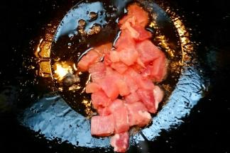 锅中加入植物油开小火，油温7成热放入猪肉块炒至变色。