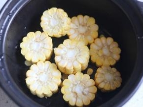 砂锅中倒入玉米。