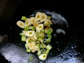 锅中倒入植物油开小火，油温七成热放入葱蒜炒香。