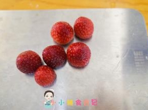 把草莓蒂切掉，这样就是平的可以立住，把草莓顶盖切掉做雪人的帽子