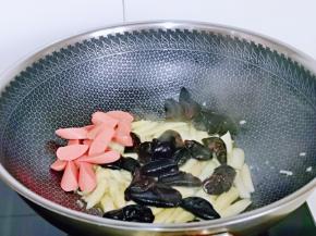 加入火腿块，泡发的黑木耳翻炒均匀。