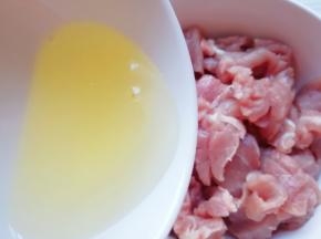 将切好的瘦肉块放进大碗里面，加入一个蛋清。