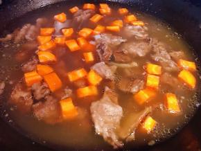 取走调料包将胡萝卜丁放入锅中中火炖5分钟