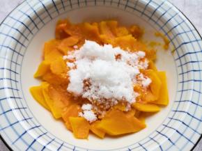 蒸熟的南瓜片从蒸锅里取出，放进大一点的碗里，加入纯牛奶和绵白糖。