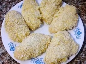 鸡翅依次裹好面包糠摆在盘中准备炸起来
