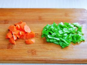 青椒洗干净，去根去籽，切小块，胡萝卜去皮洗干净，切小菱形块。(胡萝卜也可以用红椒)
