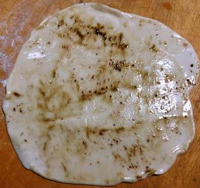 取出一小块面团揉好擀成薄饼涂抹一层薄油撒上大料面和花椒面蘸匀