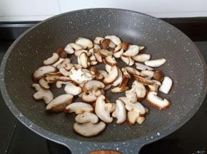 锅加油烧热下入蒜爆香，下入香菇片翻炒，将香菇炒出香味。